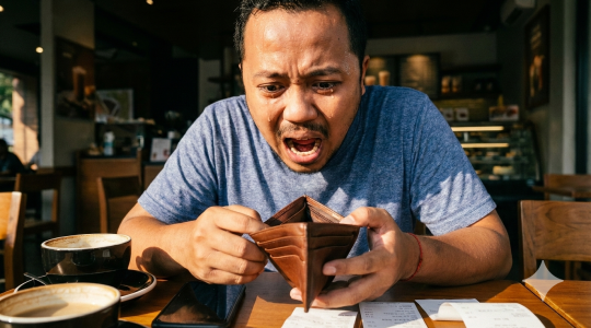 Person holding a paper boat.
